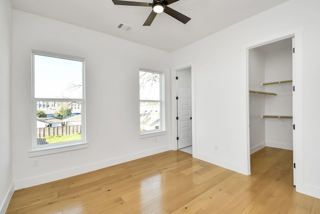 unfurnished bedroom with light wood-type flooring, visible vents, and baseboards