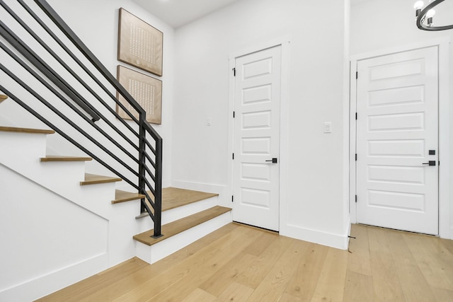 stairs with baseboards and wood finished floors