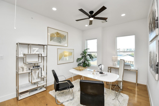 dining area featuring baseboards, visible vents, wood finished floors, and recessed lighting