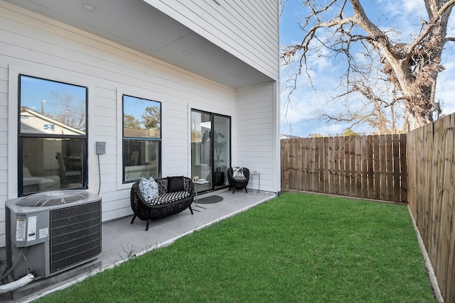 view of yard with a fenced backyard, a patio, and central air condition unit