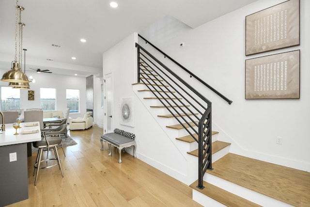 stairway with wood-type flooring, visible vents, baseboards, and recessed lighting