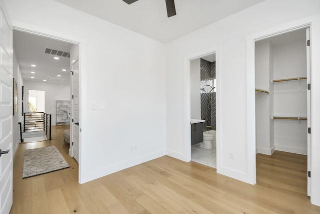 bedroom with recessed lighting, visible vents, baseboards, light wood-style floors, and a spacious closet