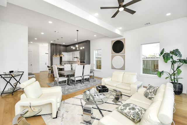 living area with recessed lighting, plenty of natural light, and light wood finished floors