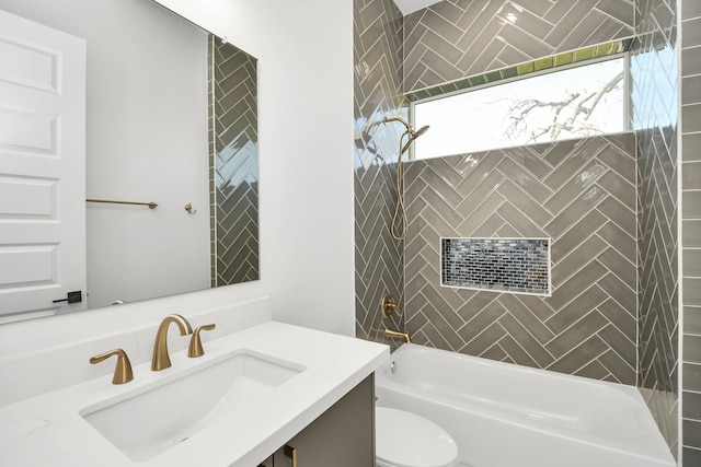 bathroom featuring toilet, plenty of natural light, vanity, and washtub / shower combination