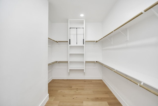 spacious closet featuring light wood-style flooring