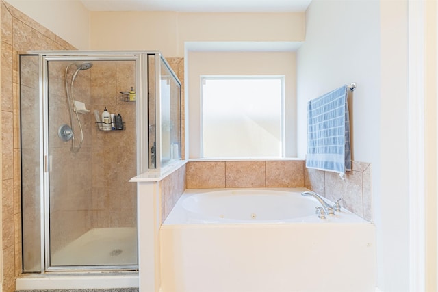 bathroom with a stall shower and a garden tub