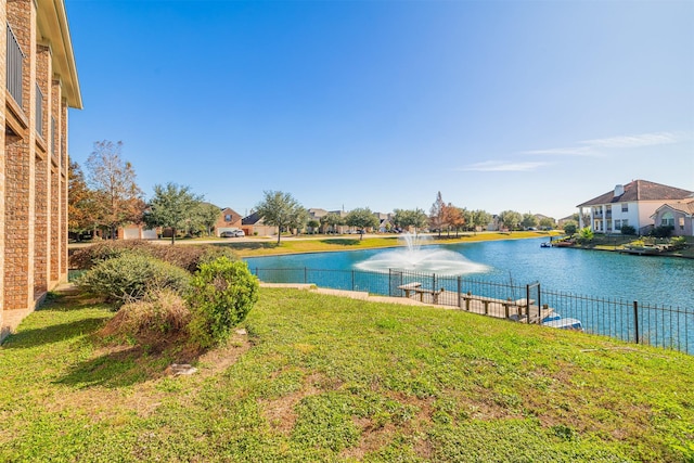 view of water feature featuring fence and a residential view