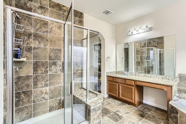 bathroom with a shower stall, visible vents, a bath, and vanity