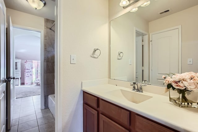 full bathroom featuring tile patterned flooring, vanity, visible vents, and tub / shower combination