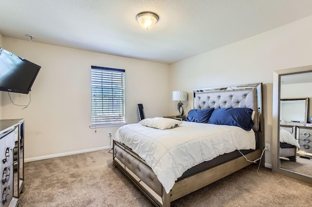 bedroom featuring light carpet and baseboards