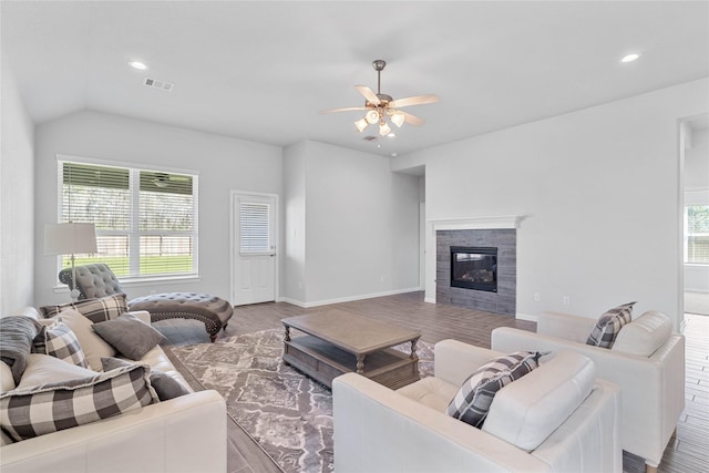 living area featuring a fireplace, visible vents, wood finished floors, and recessed lighting