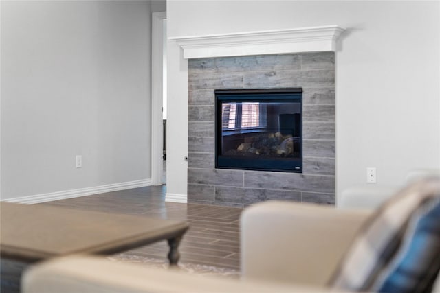 room details with a fireplace, baseboards, and wood finished floors