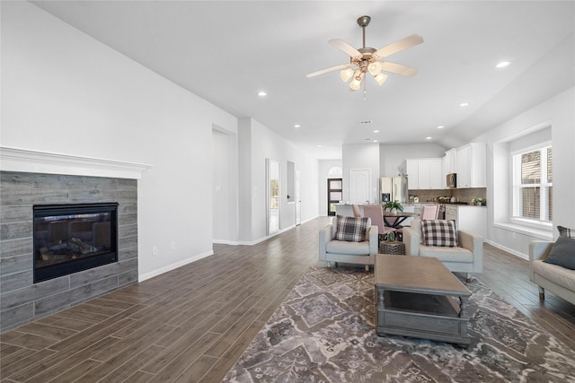 living area with a tile fireplace, dark wood finished floors, baseboards, and recessed lighting