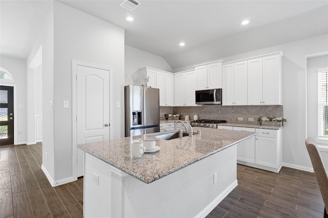 kitchen featuring appliances with stainless steel finishes, plenty of natural light, and decorative backsplash