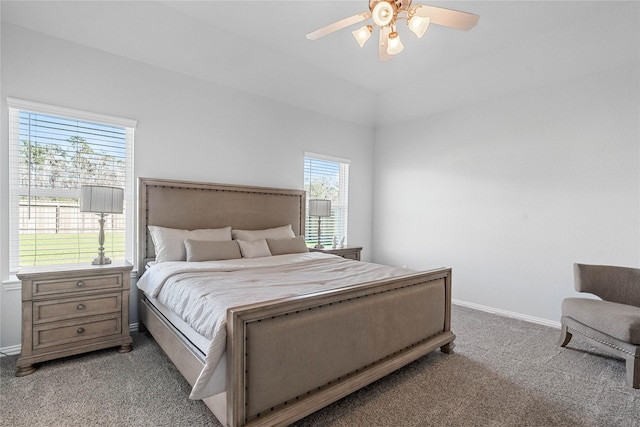 bedroom with a ceiling fan, light colored carpet, and baseboards