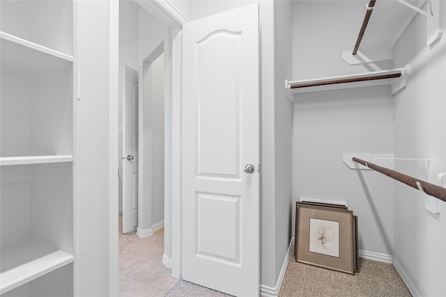 spacious closet with light tile patterned flooring