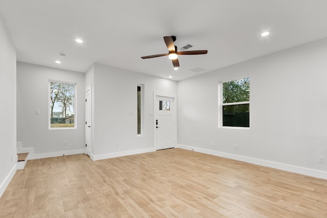 unfurnished room with light wood-type flooring, visible vents, baseboards, and recessed lighting