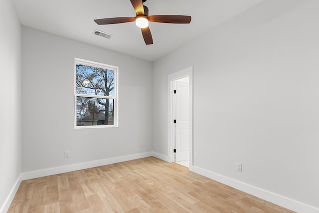 unfurnished room with baseboards, ceiling fan, visible vents, and light wood-style floors