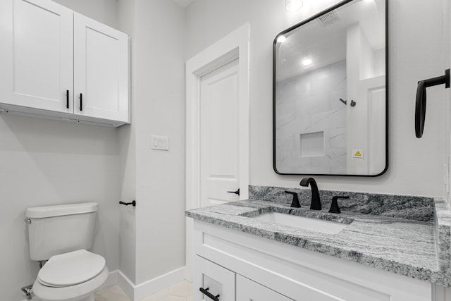 full bath featuring baseboards, vanity, toilet, and walk in shower