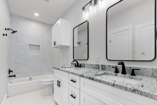 bathroom featuring toilet, double vanity, tub / shower combination, and a sink