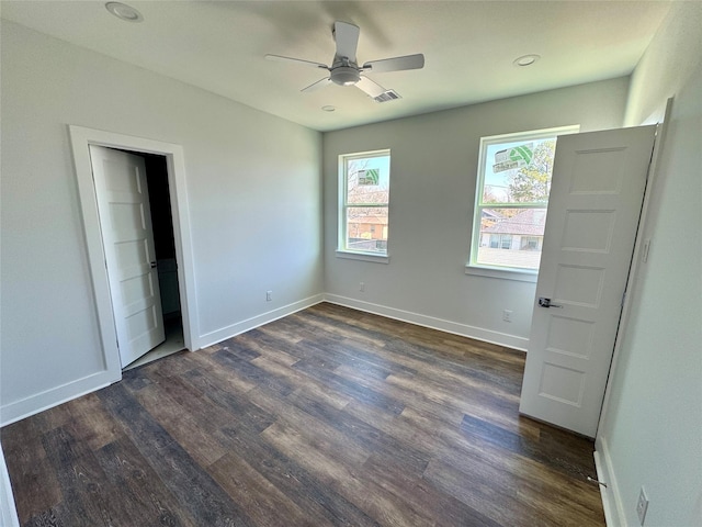 unfurnished bedroom featuring dark wood-style floors, recessed lighting, baseboards, and a ceiling fan