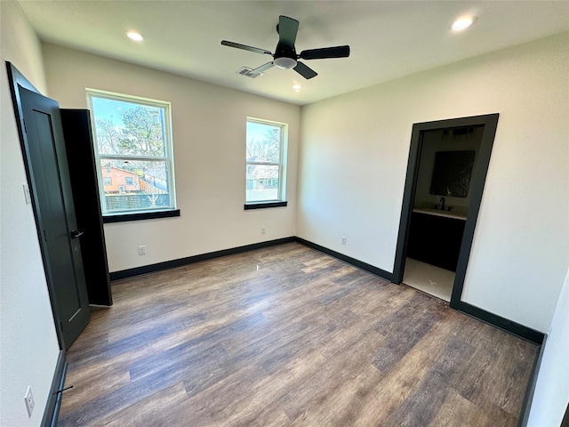 unfurnished bedroom featuring recessed lighting, visible vents, baseboards, and wood finished floors