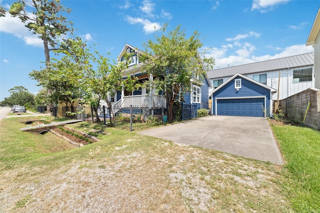 view of front of house featuring a garage, a front yard, fence, and an outdoor structure