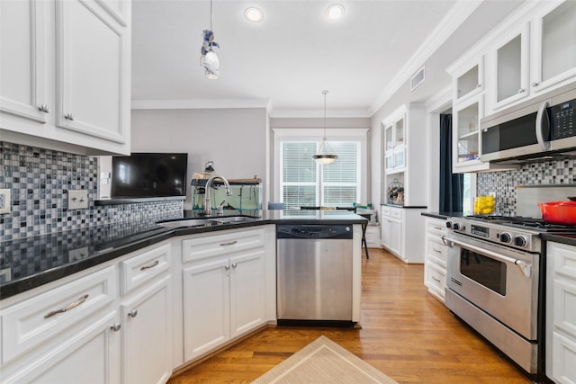 kitchen featuring a sink, visible vents, white cabinets, appliances with stainless steel finishes, and dark countertops