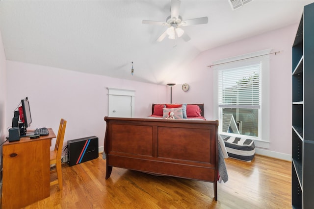 bedroom featuring lofted ceiling, baseboards, visible vents, and light wood finished floors