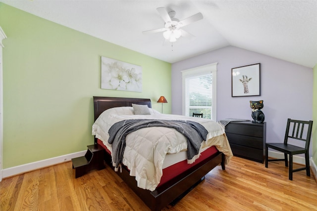 bedroom with lofted ceiling, ceiling fan, light wood finished floors, and baseboards