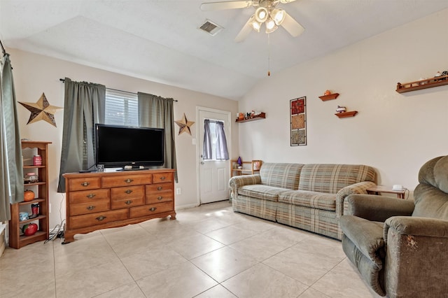 living area featuring lofted ceiling, light tile patterned floors, ceiling fan, and visible vents