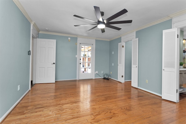 unfurnished bedroom featuring baseboards, wood finished floors, and crown molding