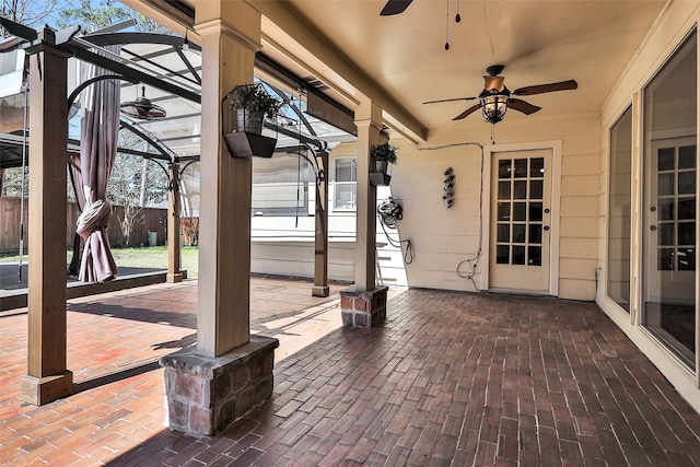 view of patio / terrace with glass enclosure and ceiling fan