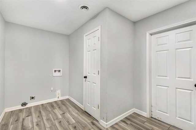 laundry room featuring hookup for a washing machine, visible vents, wood tiled floor, electric dryer hookup, and laundry area