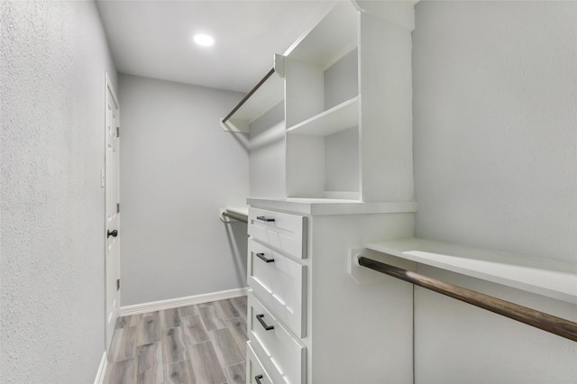 walk in closet featuring light wood-style flooring