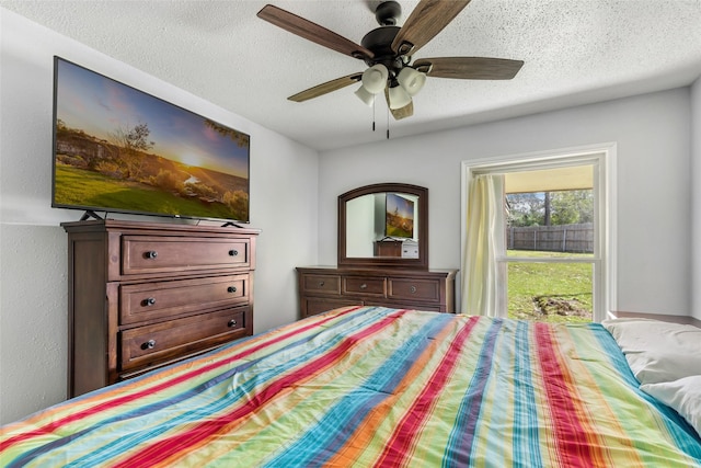 bedroom featuring a ceiling fan and a textured ceiling