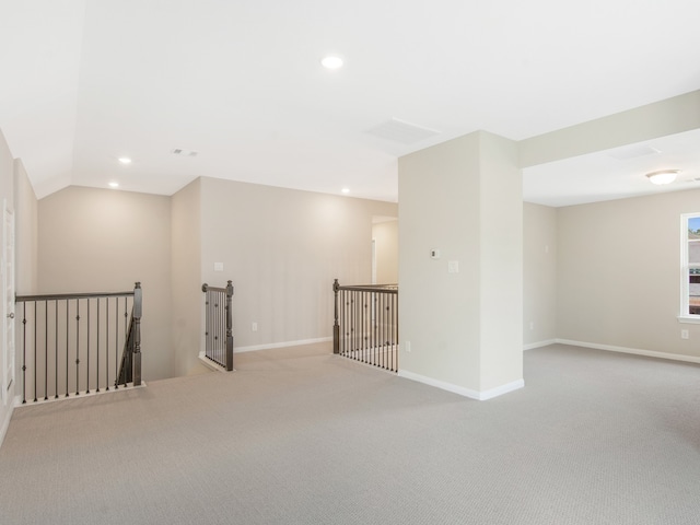 unfurnished room with baseboards, carpet, lofted ceiling, and recessed lighting