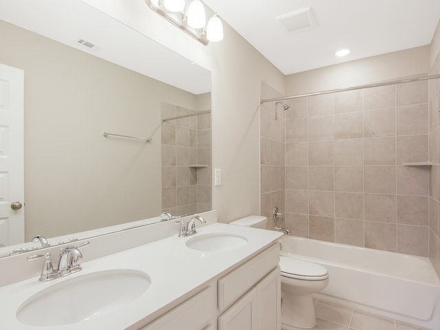 full bath featuring toilet, a sink, visible vents, and tile patterned floors