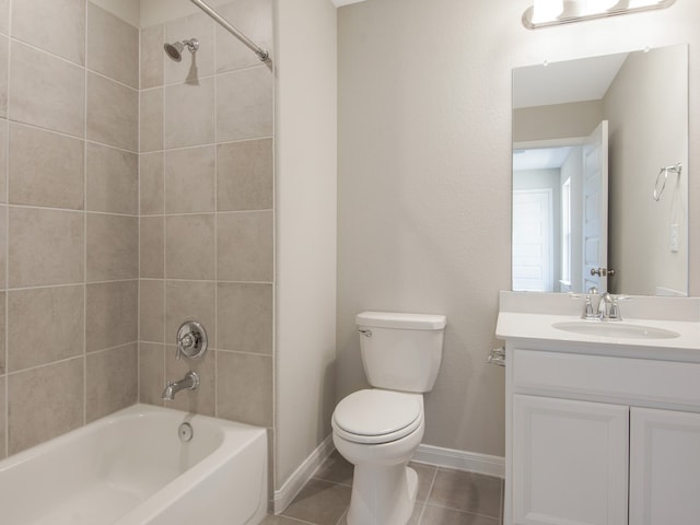 bathroom with baseboards, toilet, vanity, tile patterned flooring, and shower / bathtub combination