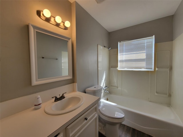 bathroom with toilet, vanity, and washtub / shower combination