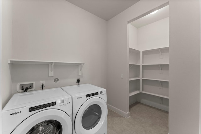 laundry room with laundry area, baseboards, and washing machine and clothes dryer