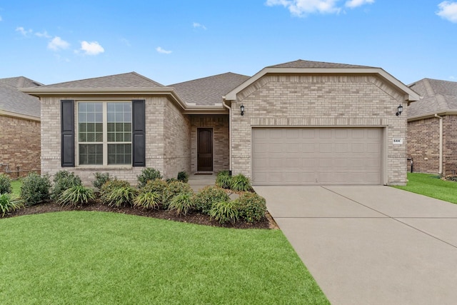 view of front of home with a garage, brick siding, and a front yard