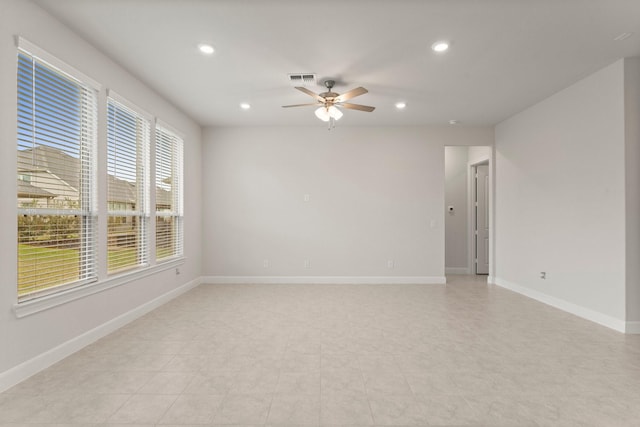 empty room with a ceiling fan, recessed lighting, visible vents, and baseboards