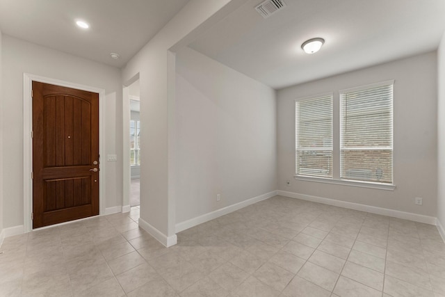 foyer entrance featuring visible vents, baseboards, and light tile patterned floors