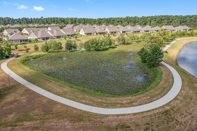 birds eye view of property with a water view and a residential view