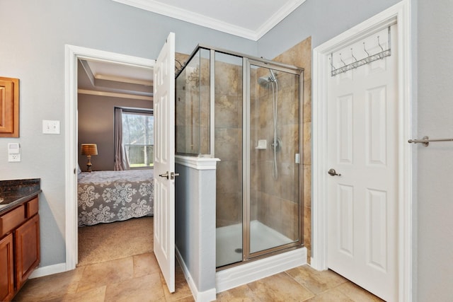 bathroom with ensuite bathroom, vanity, baseboards, ornamental molding, and a stall shower