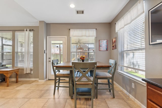 dining space with visible vents, baseboards, and light tile patterned floors