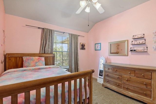 bedroom with a ceiling fan, light colored carpet, vaulted ceiling, and baseboards