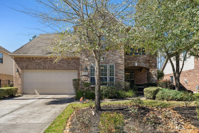 view of front of home with brick siding, a shingled roof, concrete driveway, a garage, and stone siding