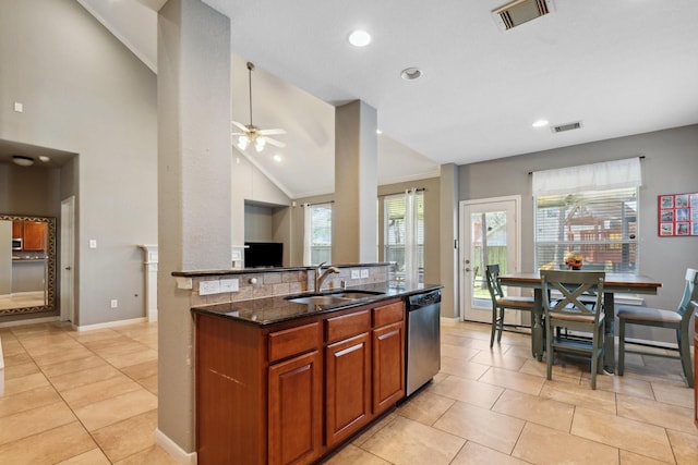 kitchen with stainless steel appliances, dark stone counters, visible vents, and a sink